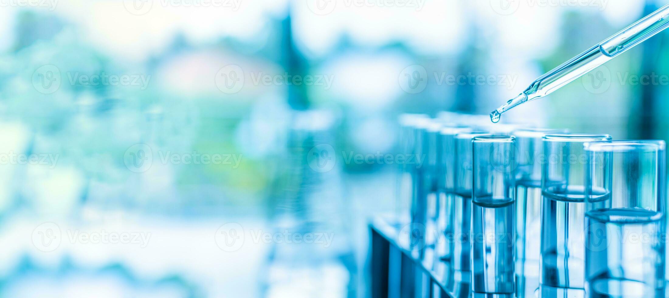 Chemistry experiments in science labs. Concept of a chemical, scientific experiment. Drop chemical matter into a test tube is place it on a white desk. Closeup, copy space on left. Blurred background photo