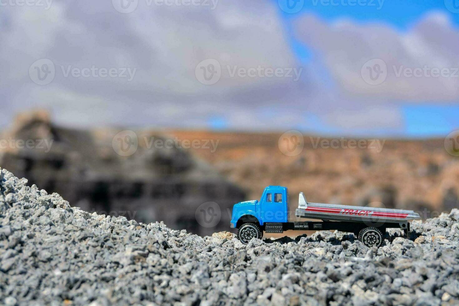 a toy truck is parked on a rocky hill photo