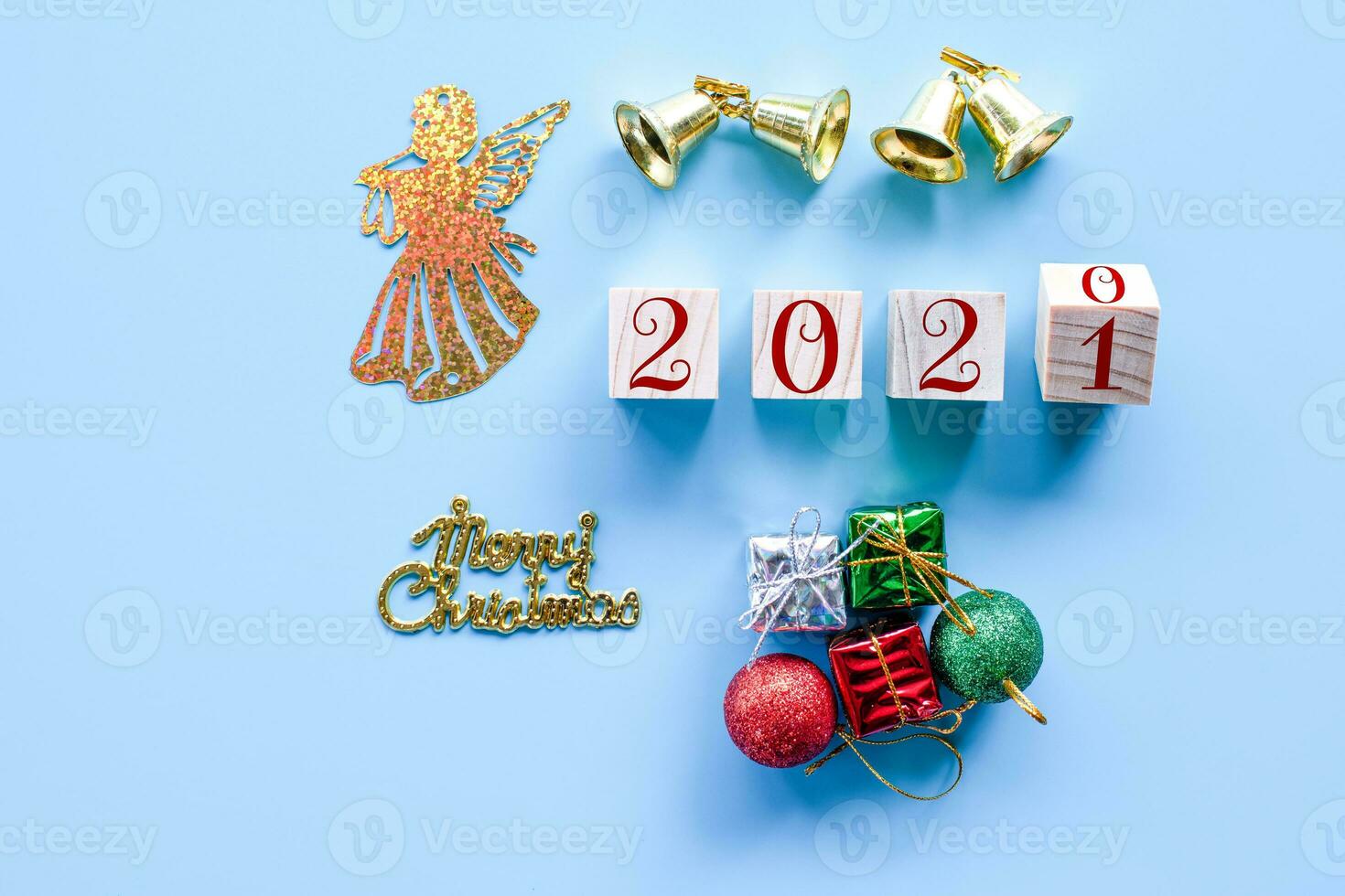 Top view and nobody. Wooden cube with word 2020 to 2021 New Year and Christmas Day concept on blue background. Closeup and copy space on left for design or text. photo