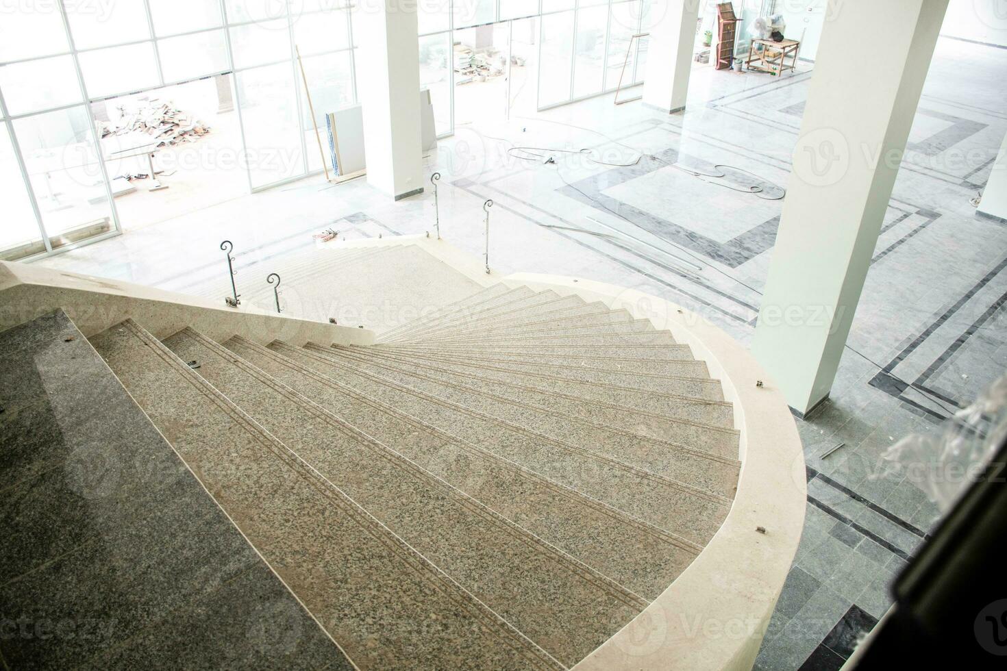 Residential space nobody. Stairs upstairs of the under construction office. The space inside the building is empty. With exterior building materials photo
