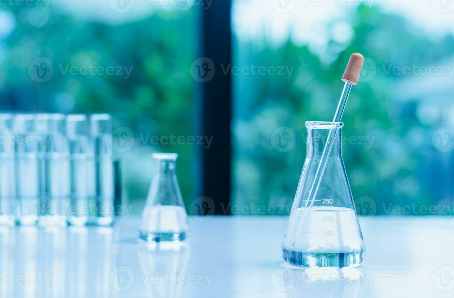 Concept of chemical, scientific experiment, monkeypox virus. Closeup, copy space on right. Chemistry experiments in science labs. Drop chemical matter into test tube place on desk. Blurred background photo