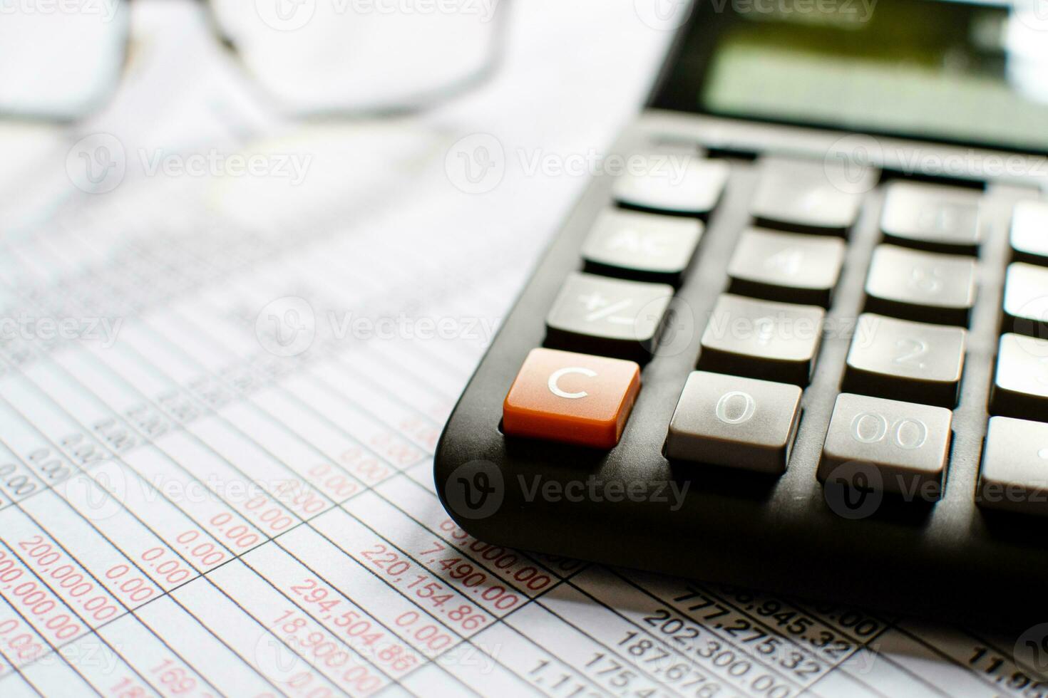 Financial accounting, Close-up numbers on paper and calculator, Many numbers on paper, Blurred background. photo