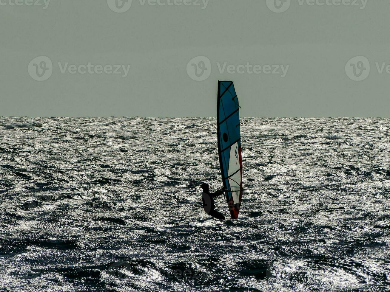 Person windsurfing in the ocean photo