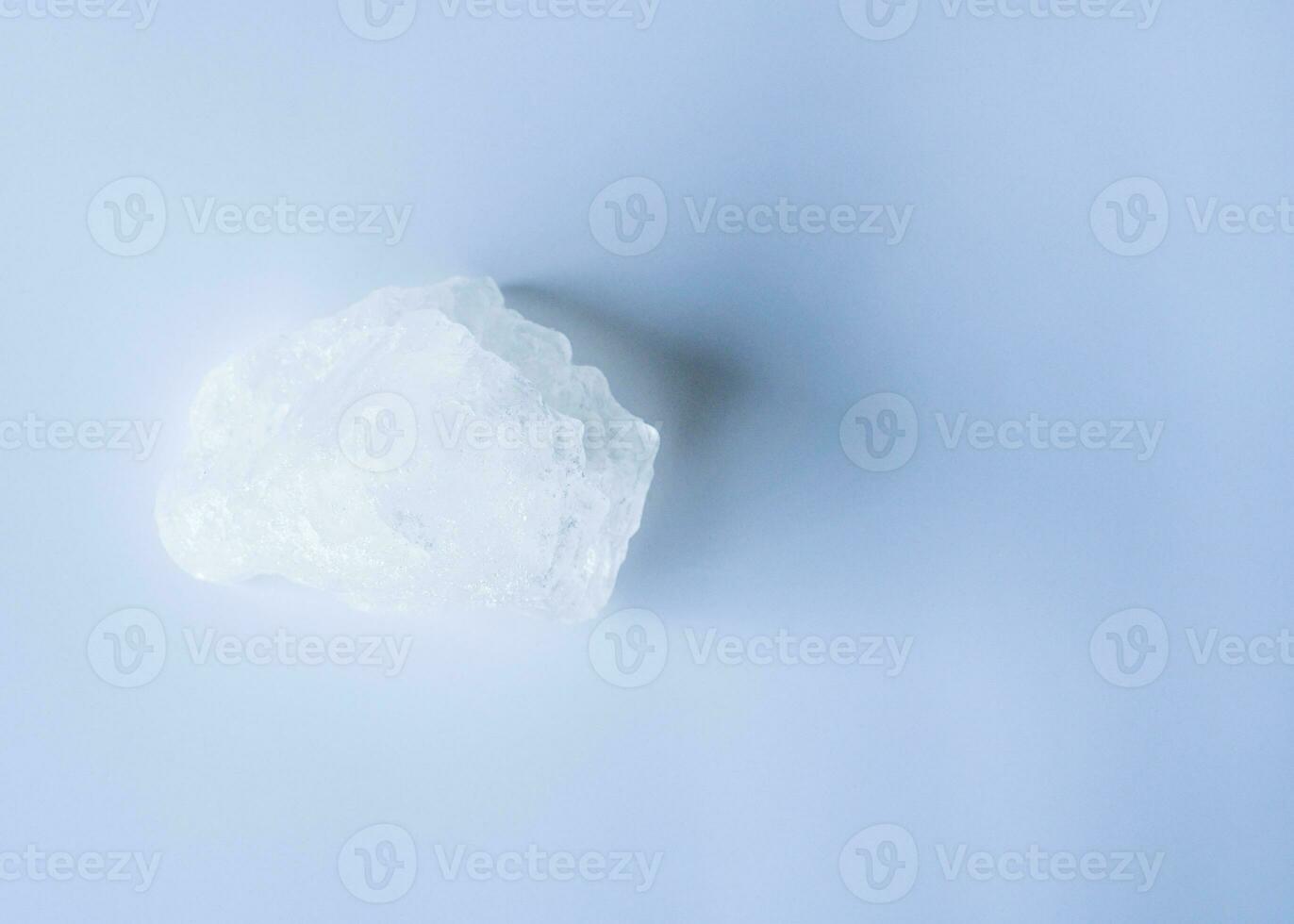 The concept for applying underarms to reduce body odor, a swing the cloudy water into the sediment to get clear water to use at home. White alum cubes on a blue background, closeup, nobody, copy space photo