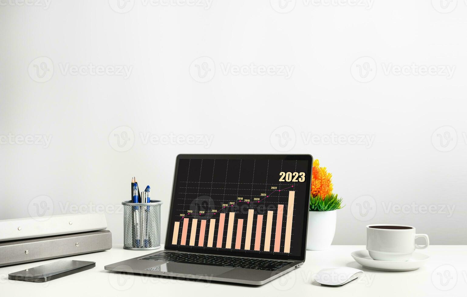 Laptop is graph displayed on the desk in the office and has Smartphone, and coffee cup. The concept of business, finance, banking, and interest is booming. Copy space on top for design, Closeup, 202 photo