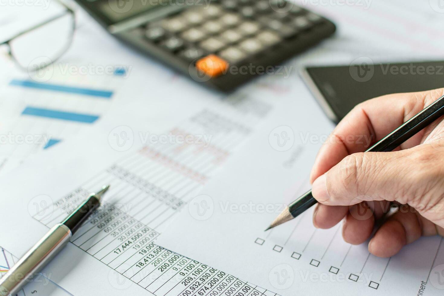 professional businessperson man hand holding pen and checking list report information data document or paperwork business of banking finance accounting on desk office for management investment stock photo