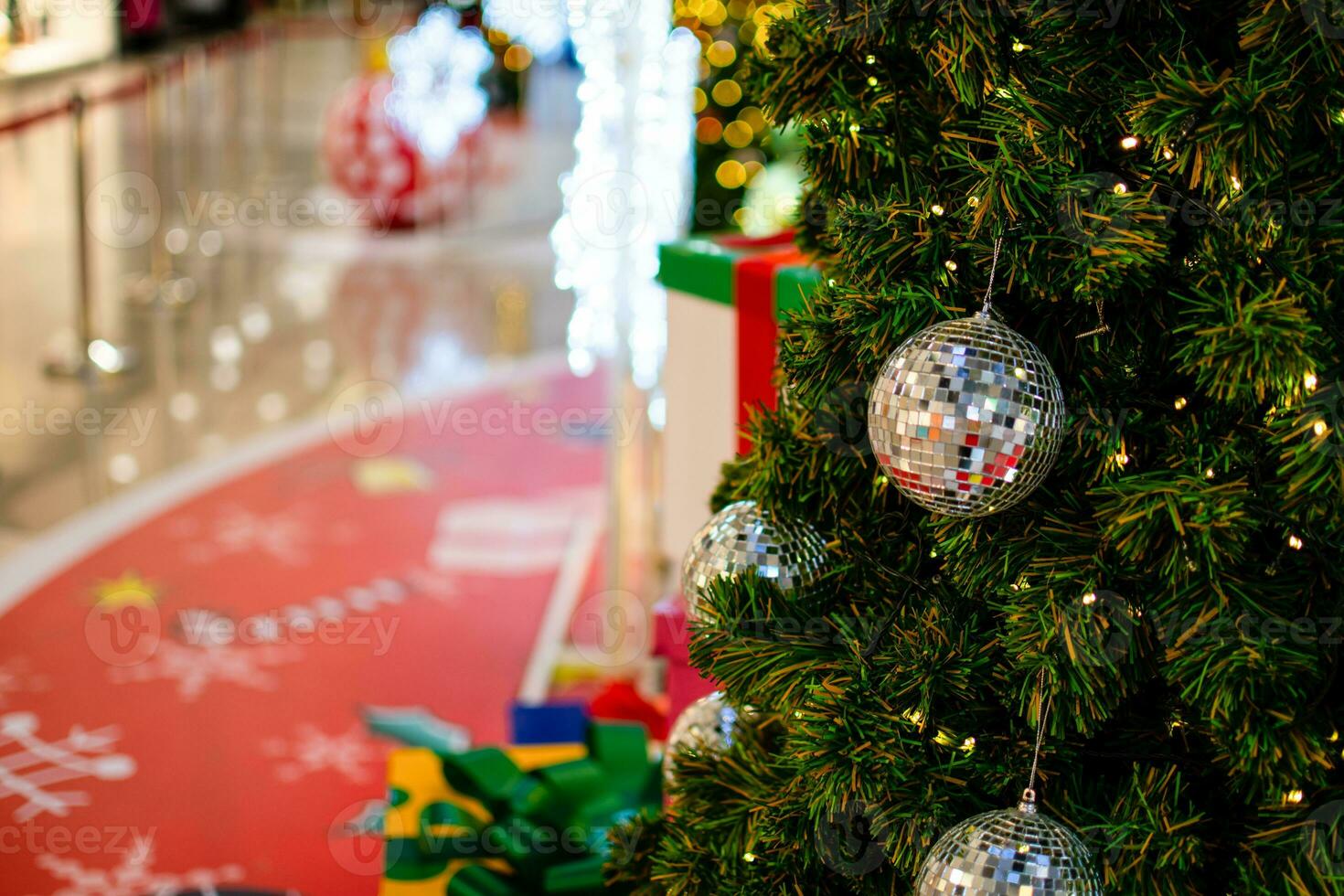 Closeup small white balls on a Christmas tree decorated 2020 with small bulbs are beautiful. Copy space and beautiful bokeh on left for design or text, blurred background. photo