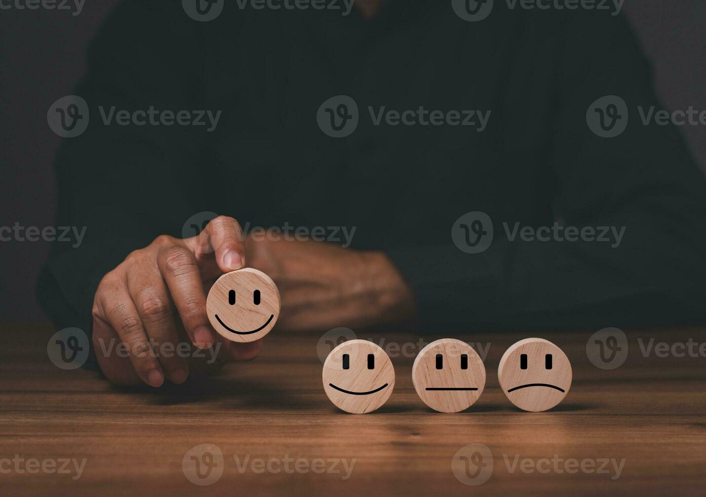 a man customer services best excellent business rating experience. Satisfaction survey concept. The hand of the businessman chooses a smiley face on a wooden block circle. Satisfaction to service mind photo