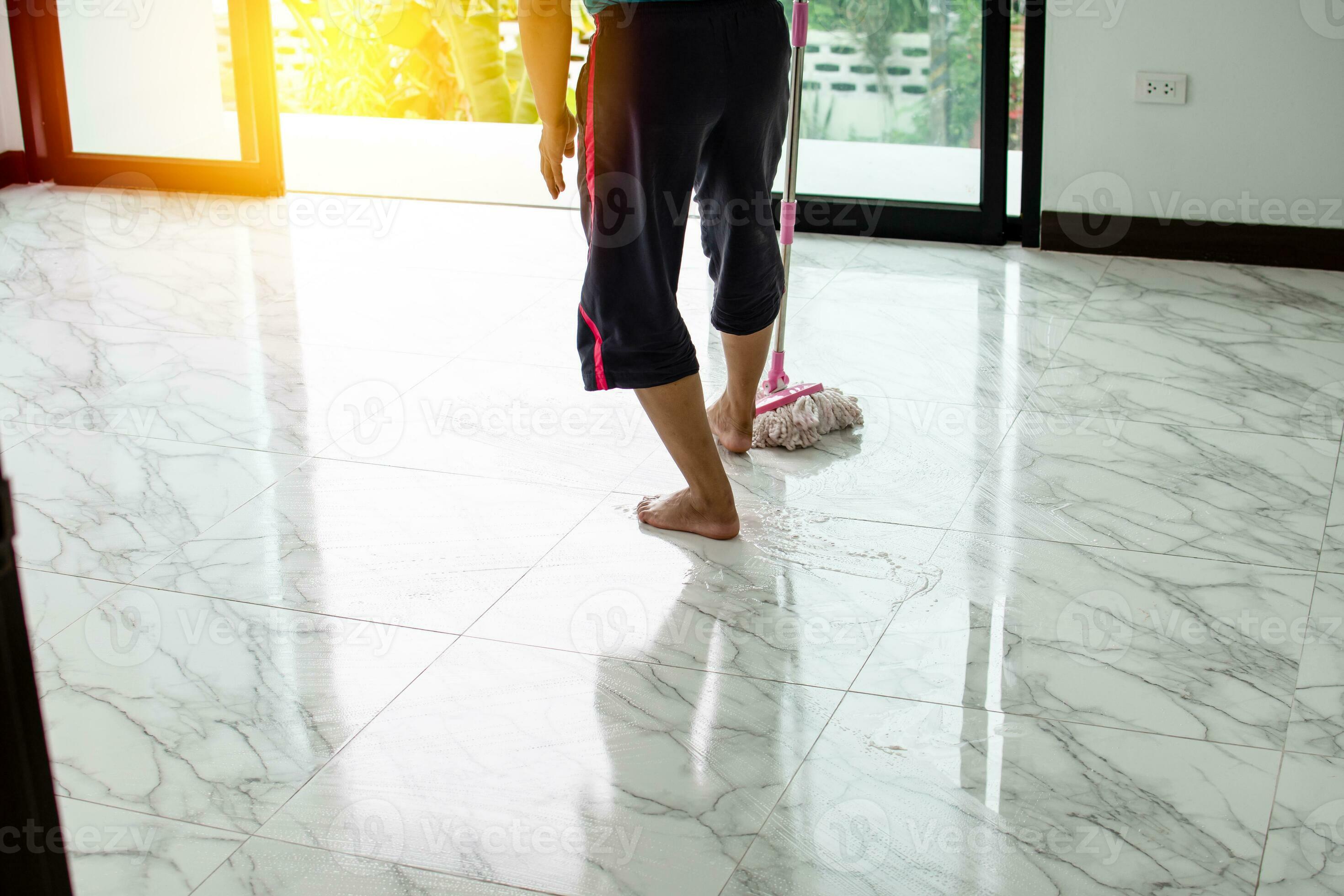 Women are mopping down the hallway to clean and rid themselves of the