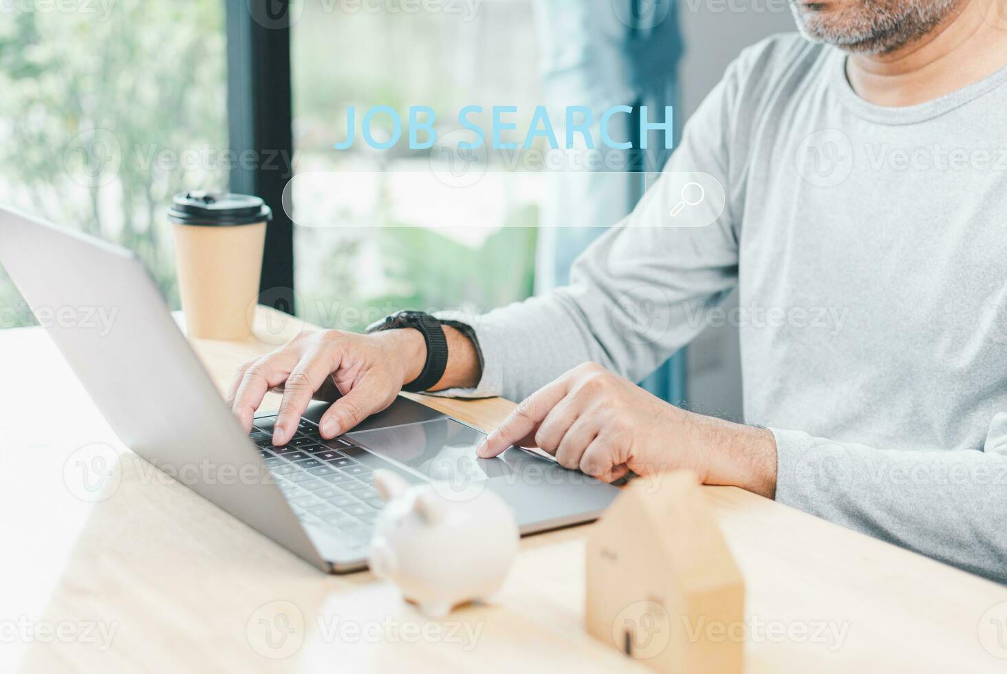 Searching Browsing Internet Data Information with search job in bar. Search Engine Optimization SEO Networking Concept. hand of businessman working with computer laptop on a wooden desk in an office photo