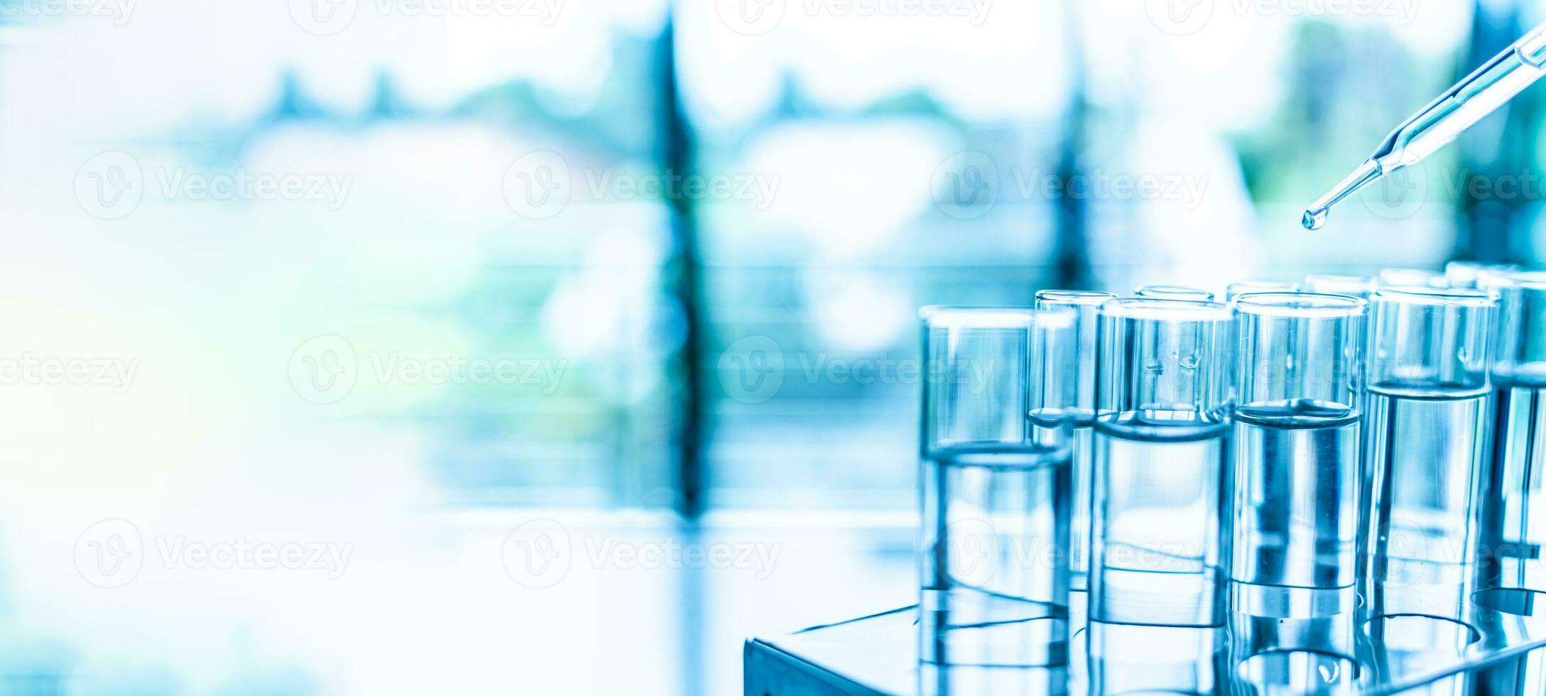 Concept of chemical, scientific experiment, monkeypox virus. Closeup, copy space on left. Chemistry experiments in science labs. Drop chemical matter into test tube place on desk. Blurred background photo