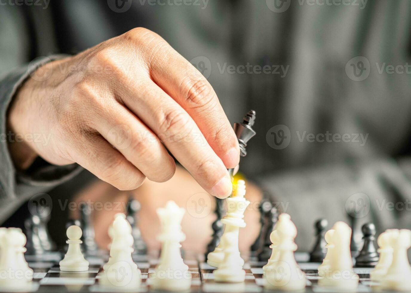 The hands of a business male business associate confident in strategy after playing chess to analyze and develop new planning. Concept of leadership and teamwork for victory and success in business. photo