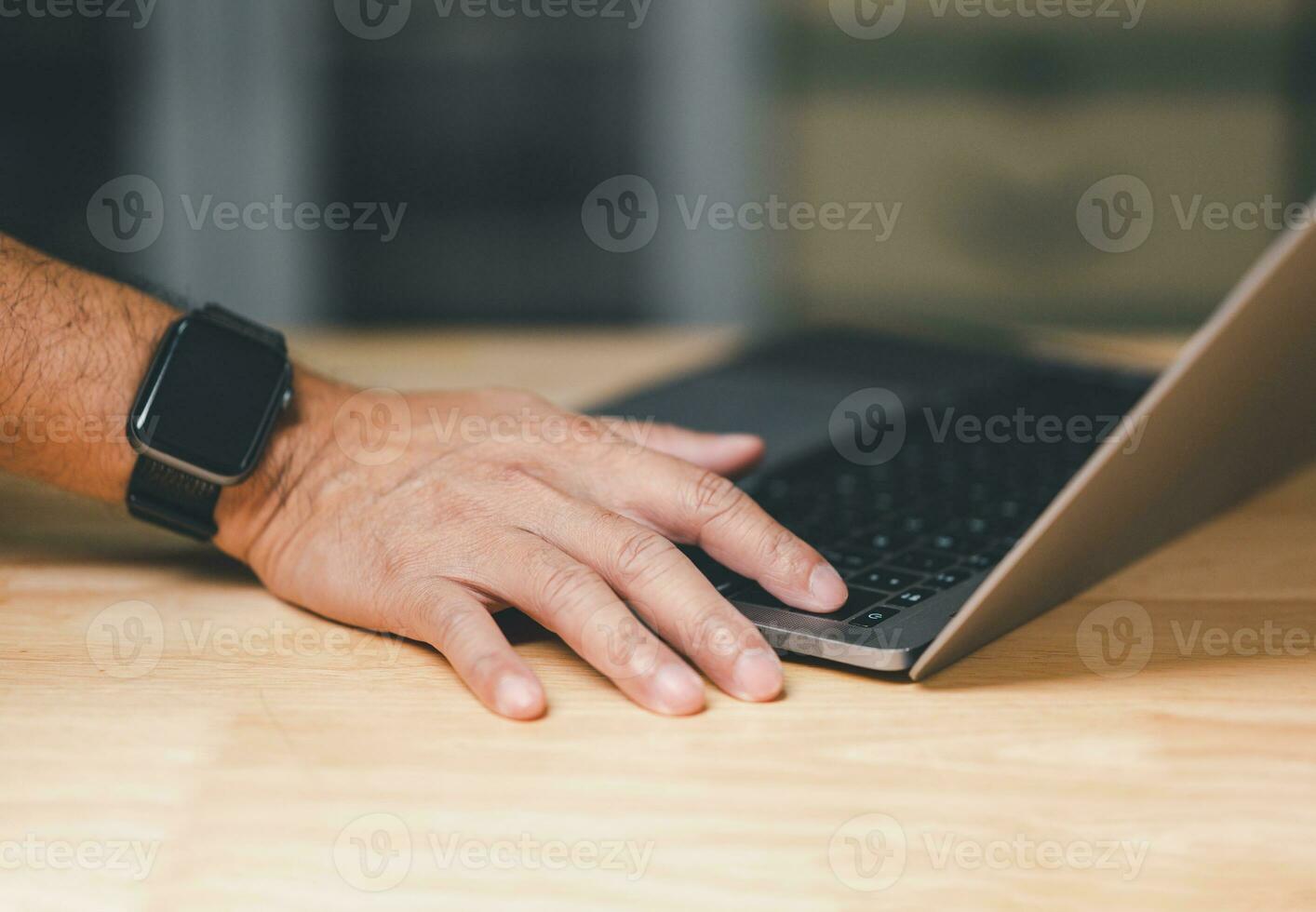 Man uses his finger to press button to turn off, closed, shut down laptop computer on desk, before going home for saving energy, save global environment. reduce global warming. world environment day photo