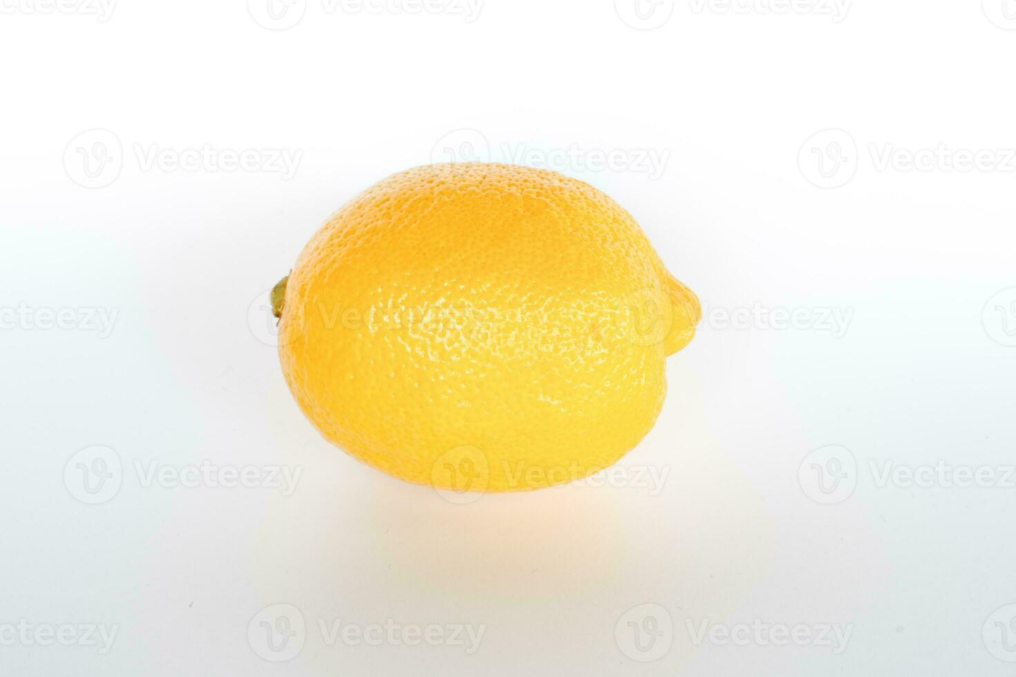 Take close-ups of one yellow lemon against a white backdrop and nobody, copy space. photo