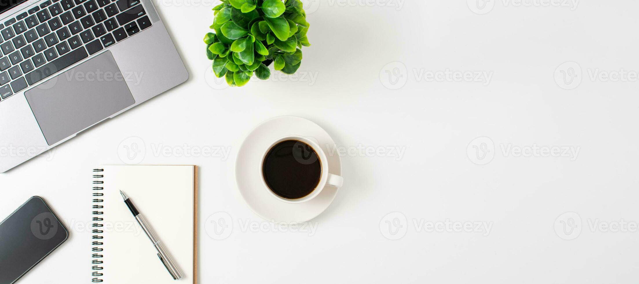 Laptop and coffee cup on a white table in the office. Working concept using technology, smartphones, notebook, internet. Copy space on right for design or text, Close up, top view white background photo