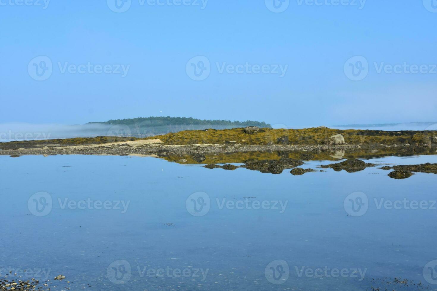 Exposed Reef With Clouds Floating Above It photo