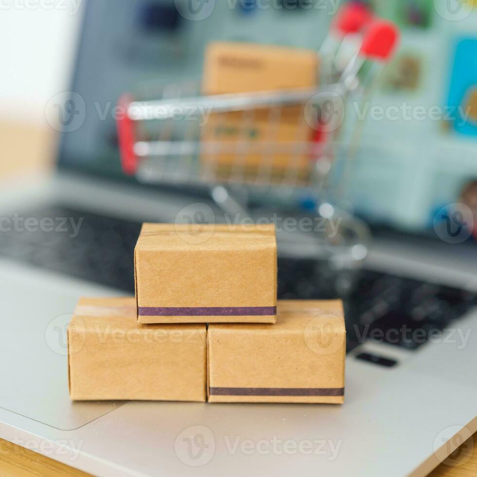 Boxes on laptop computer. online shopping, Marketplace platform website, technology, ecommerce, shipping delivery, logistics and online payment concepts photo