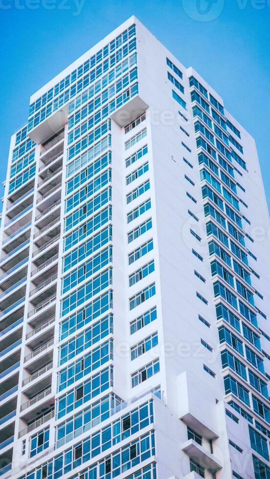 A tall white building with many windows photo