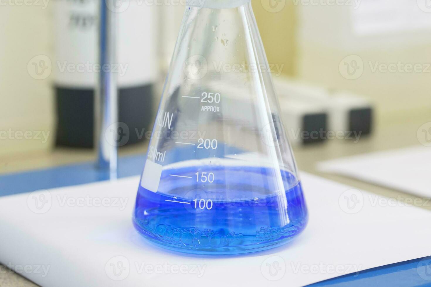 Flask with blue liquid in lab photo
