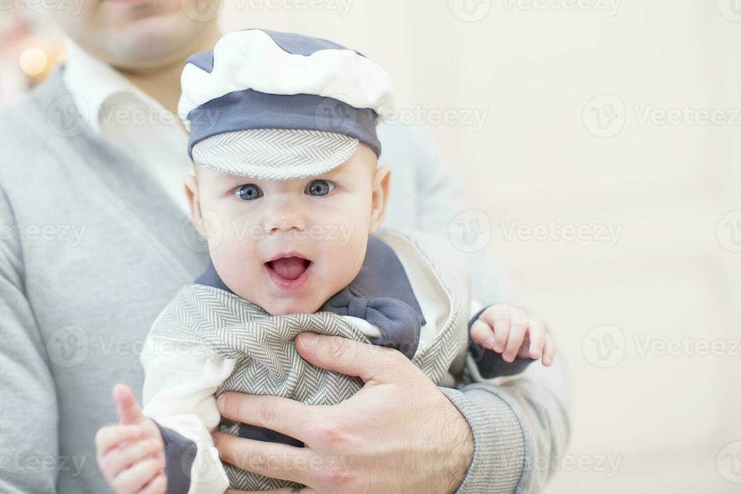 Cheerful playful baby in his father's arms. Baby and dad photo
