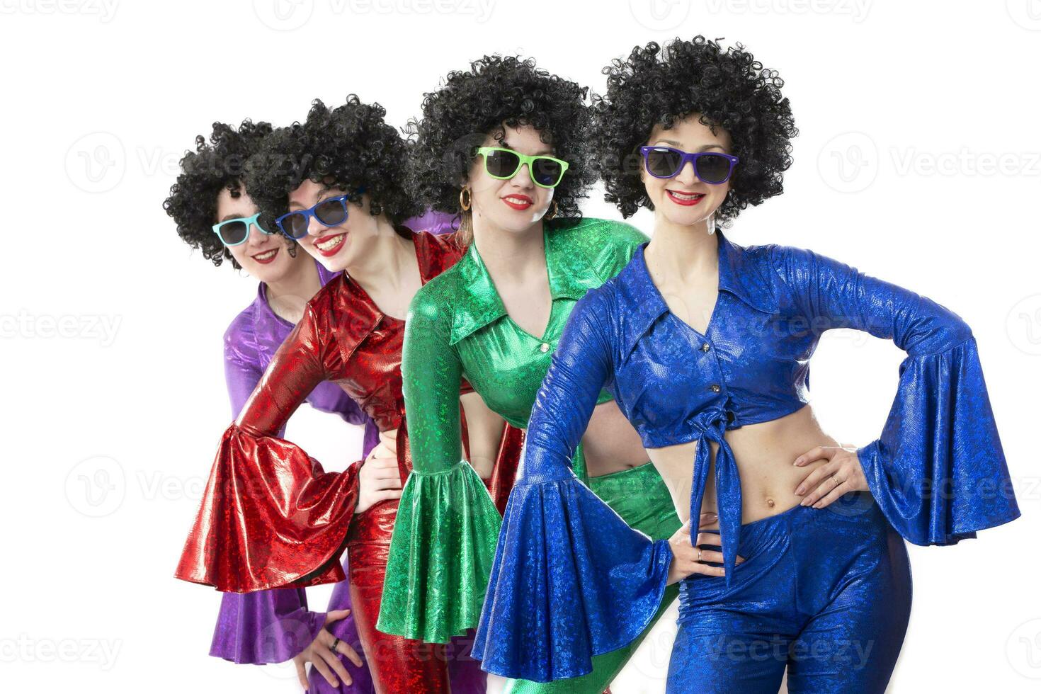 A group of girls in disco style and African wigs in colorful costumes on a white background. photo