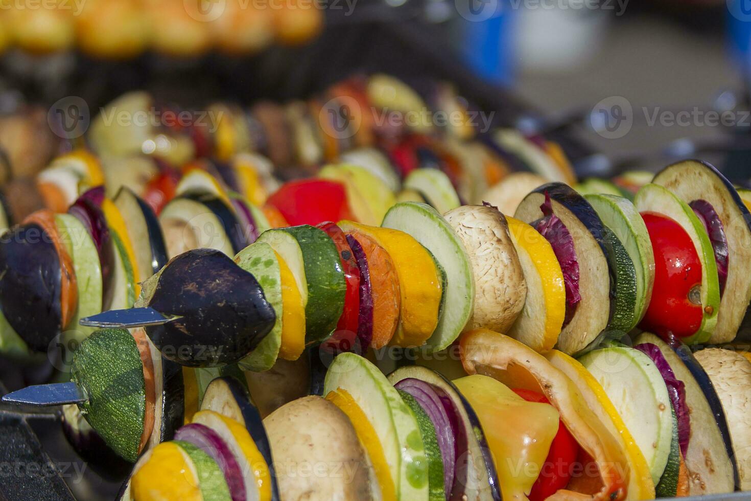 Vegetarian kebab from vegetables. On skewers zucchini, peppers, mushrooms. photo