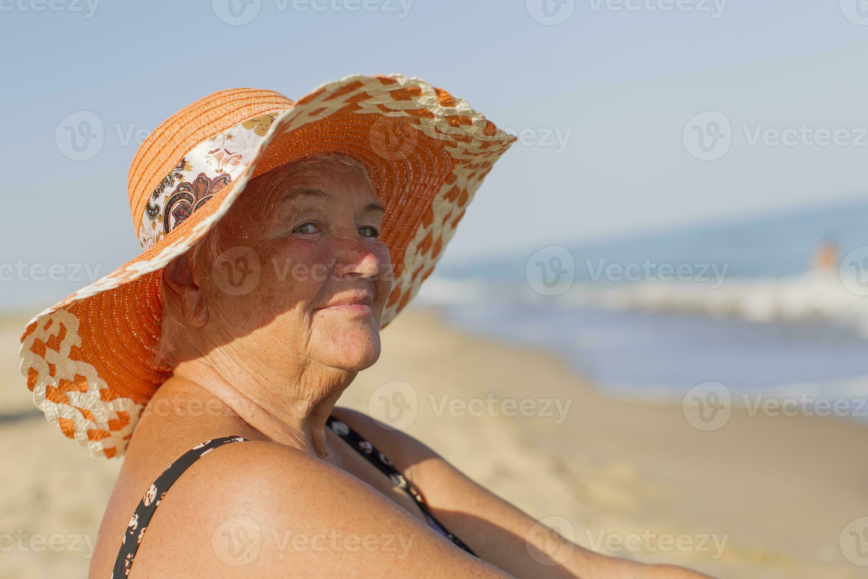 granny beach   Grandmother on vacation. Elderly woman in a bathing suit by the sea. Old  man sitting on the beach 32420855 Stock Photo at Vecteezy