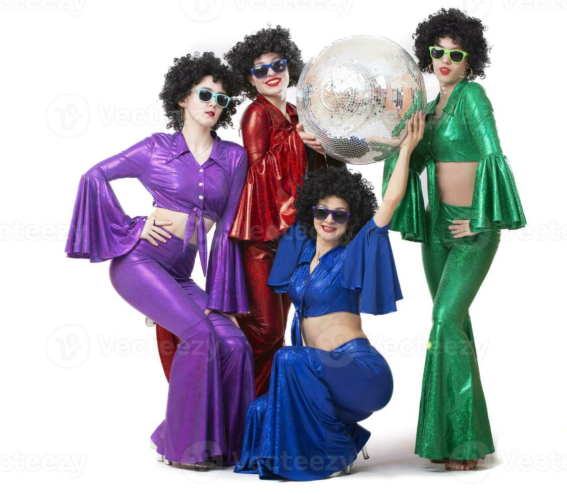 Girls in glasses and colorful disco costumes pose with a disco ball. Disco party. Halloween costume. photo