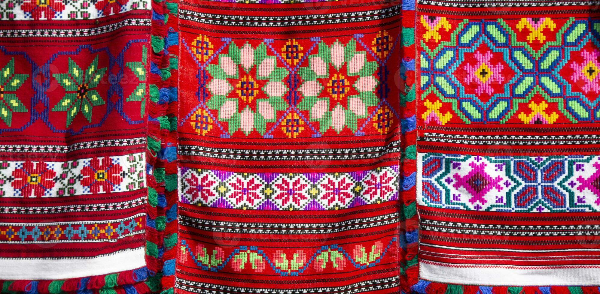 Beautiful towels, embroidered with Slavic patterns. Embroidery and manufacture of fabrics in the old days. Traditions. Ukrainian or Belarusian embroidered shirt. photo