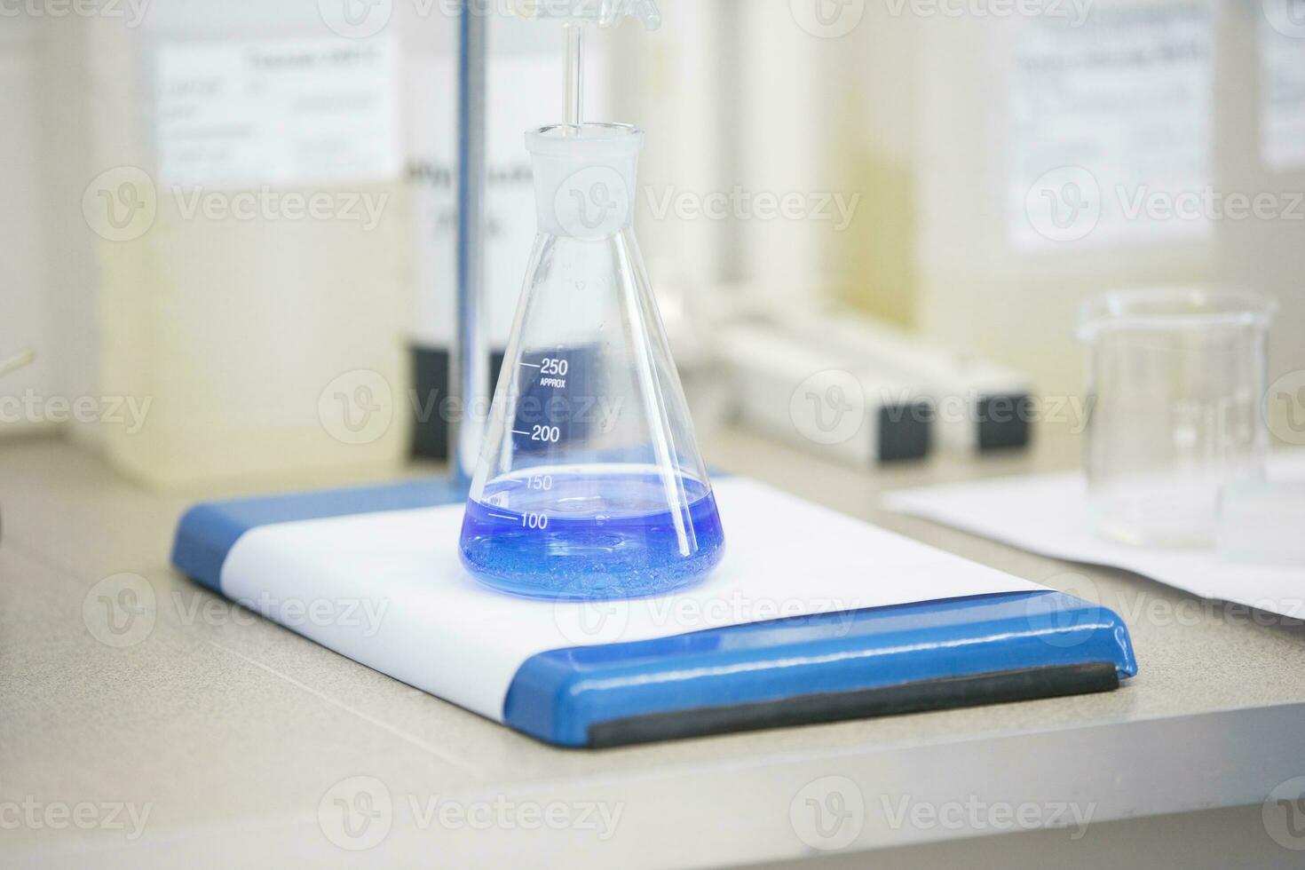 Flask with blue liquid in lab photo