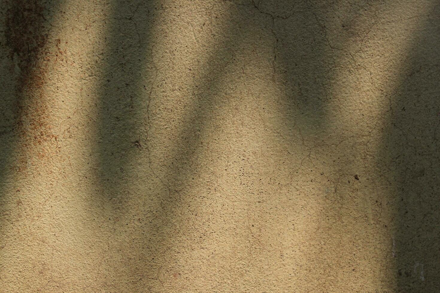 Sun shining on a cement wall background, grungy shiny wall surface, rusty cement wall backdrop photo