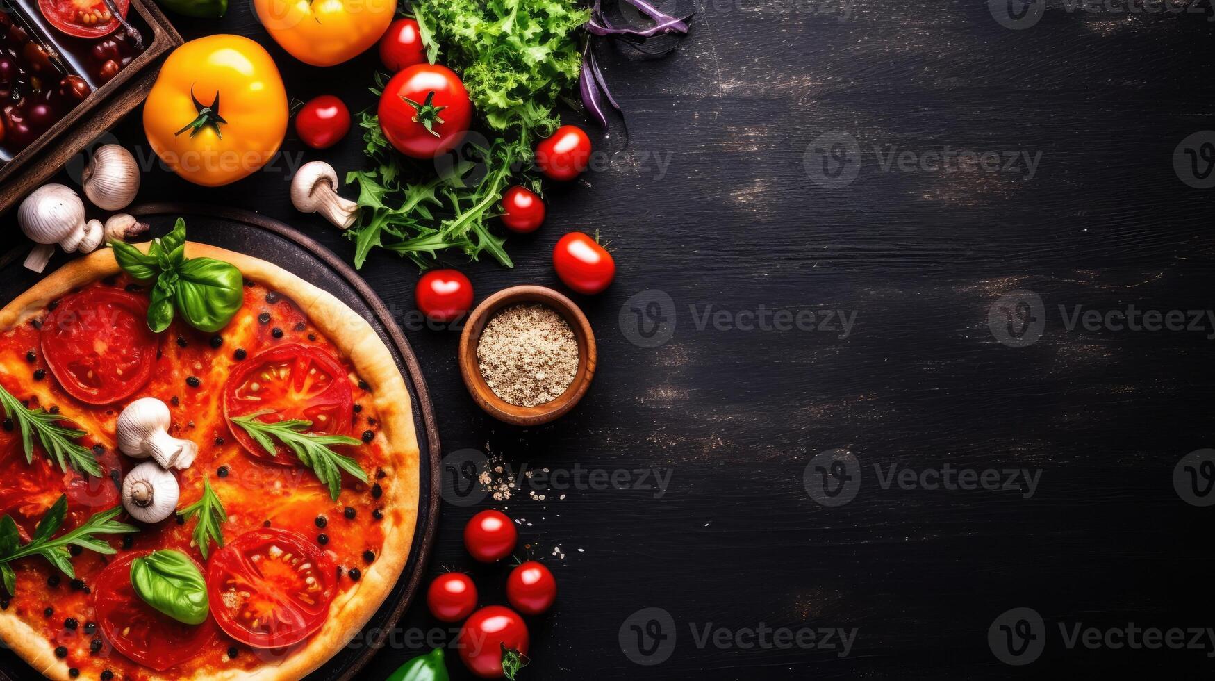 Pizza with tomatoes, mushrooms and basil on black wooden background. Copy space for text. photo