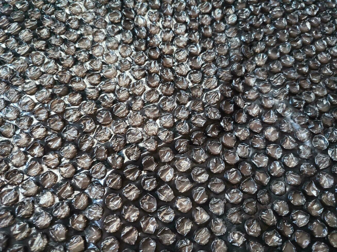 Black Bubble Wrap Or Air Cushion Film Abstract Horizontal Texture For Creative Artwork Background, Close Up, Top View, Copy Space photo