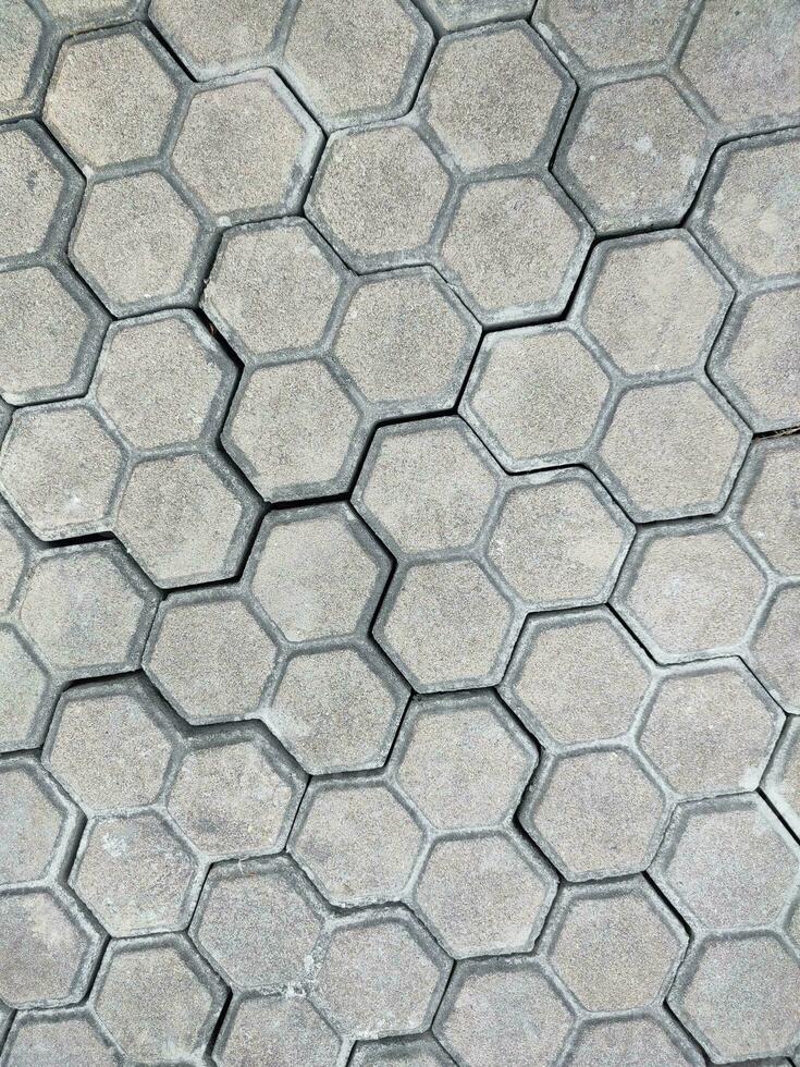 Pavement hexagonal stone background. Hexagonal paving cobble texture laid on city street photo