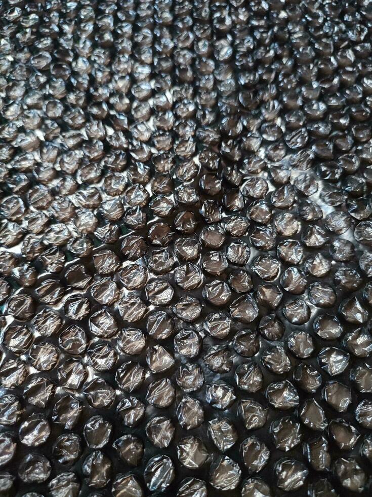 Black Bubble Wrap Or Air Cushion Film Abstract Horizontal Texture For Creative Artwork Background, Close Up, Top View, Copy Space photo