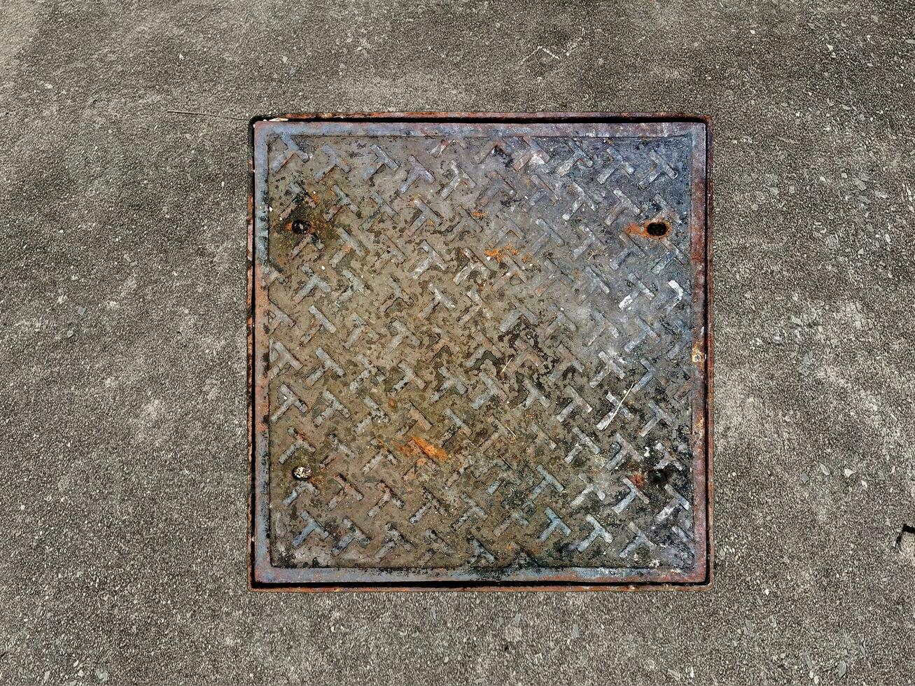 Rusted manhole cover, grunge style manhole cover, square edge, photo
