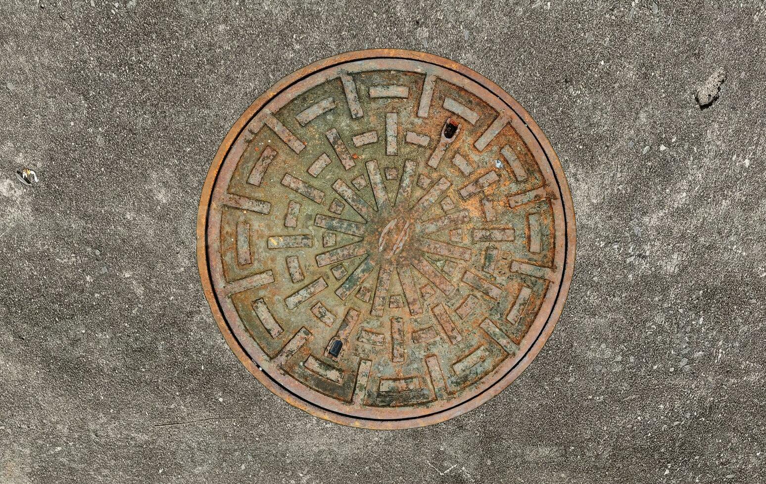 Rusted manhole cover, grunge style manhole cover, rounded edge, photo