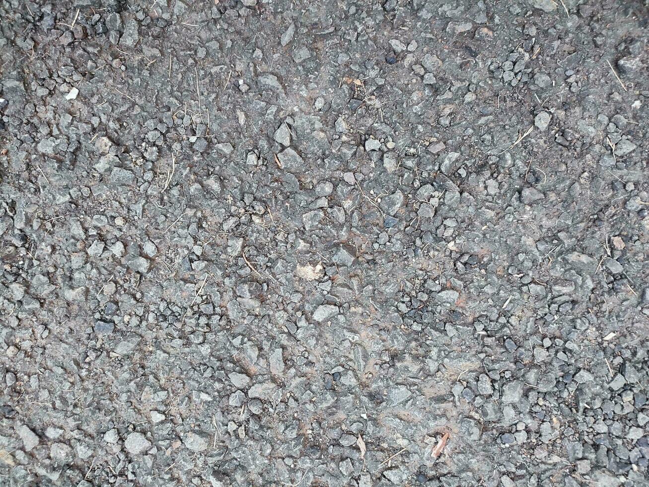 asphalt rough and rocky grunge surface, texture background, gray paved road photo