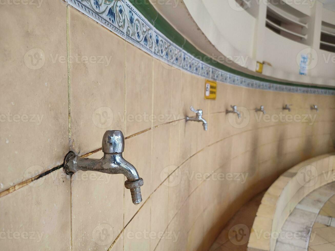 mosque ablution place, for Muslims to perform ablution before praying at the mosque. Also used for washing hands and cleaning limbs photo