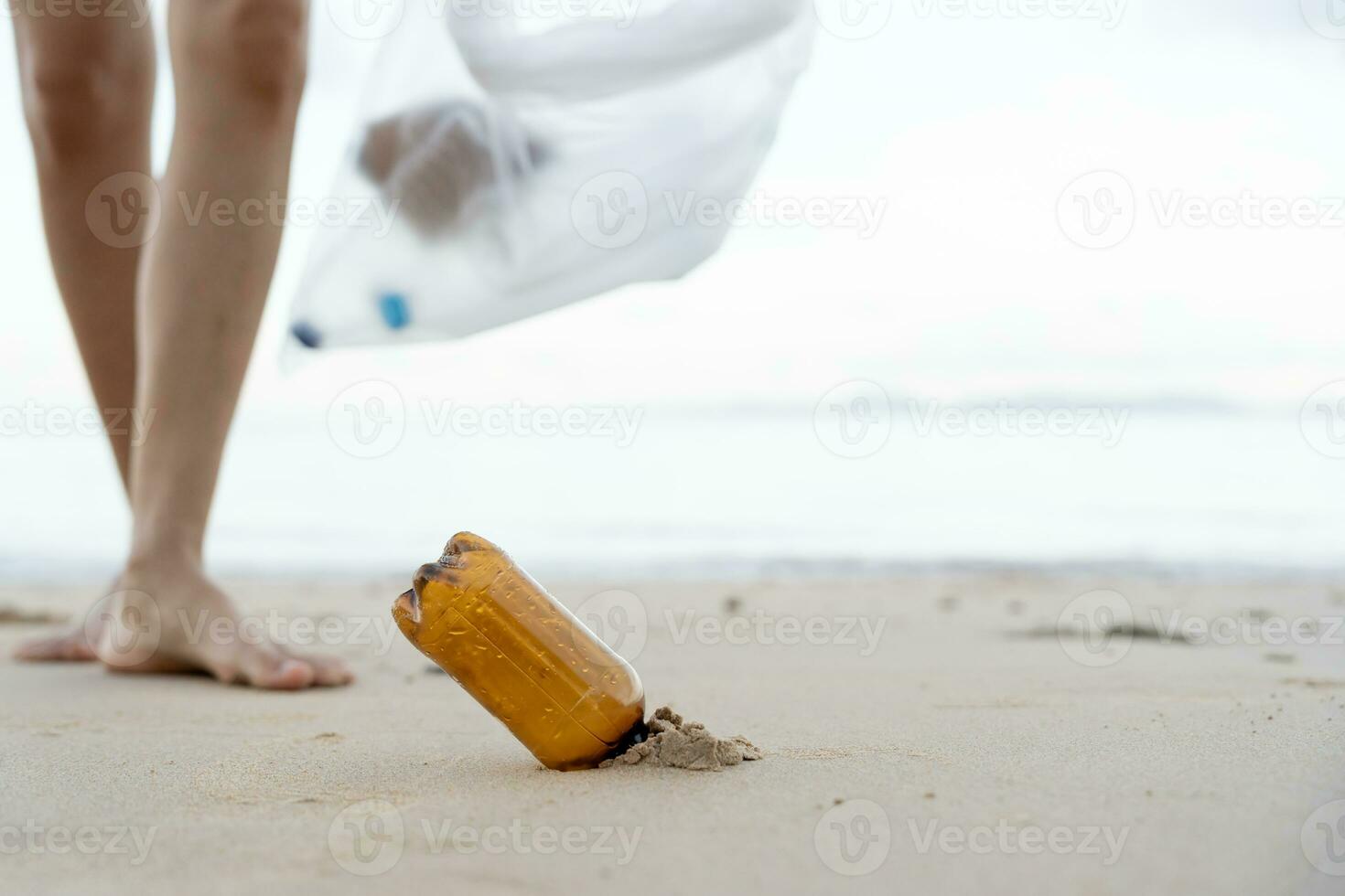 Save ocean. Volunteer pick up trash garbage at the beach and plastic bottles are difficult decompose prevent harm aquatic life. Earth, Environment, Greening planet, reduce global warming, Save world photo