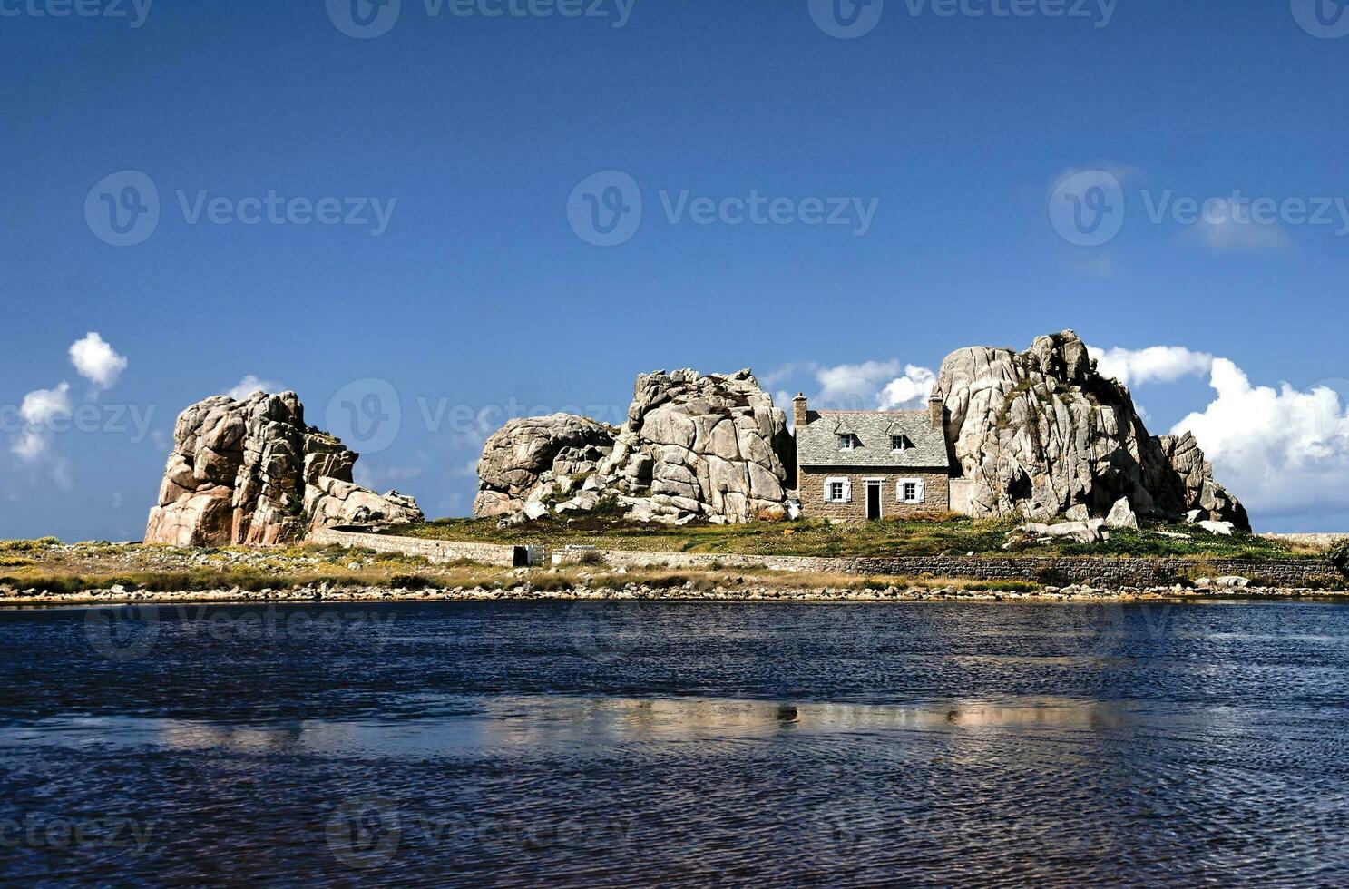 Seaside Serenity Charming Cottage Amidst Rocky Coastline photo