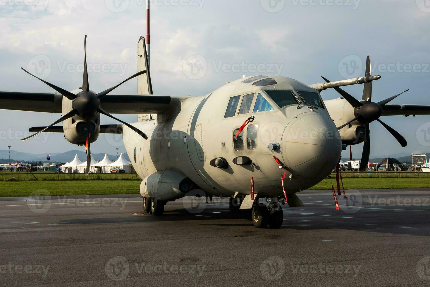 Untitled military transport plane at air base. Airport and airfield. Air force and army flight operation. Aviation and aircraft. Air lift. Military industry. Fly and flying. photo