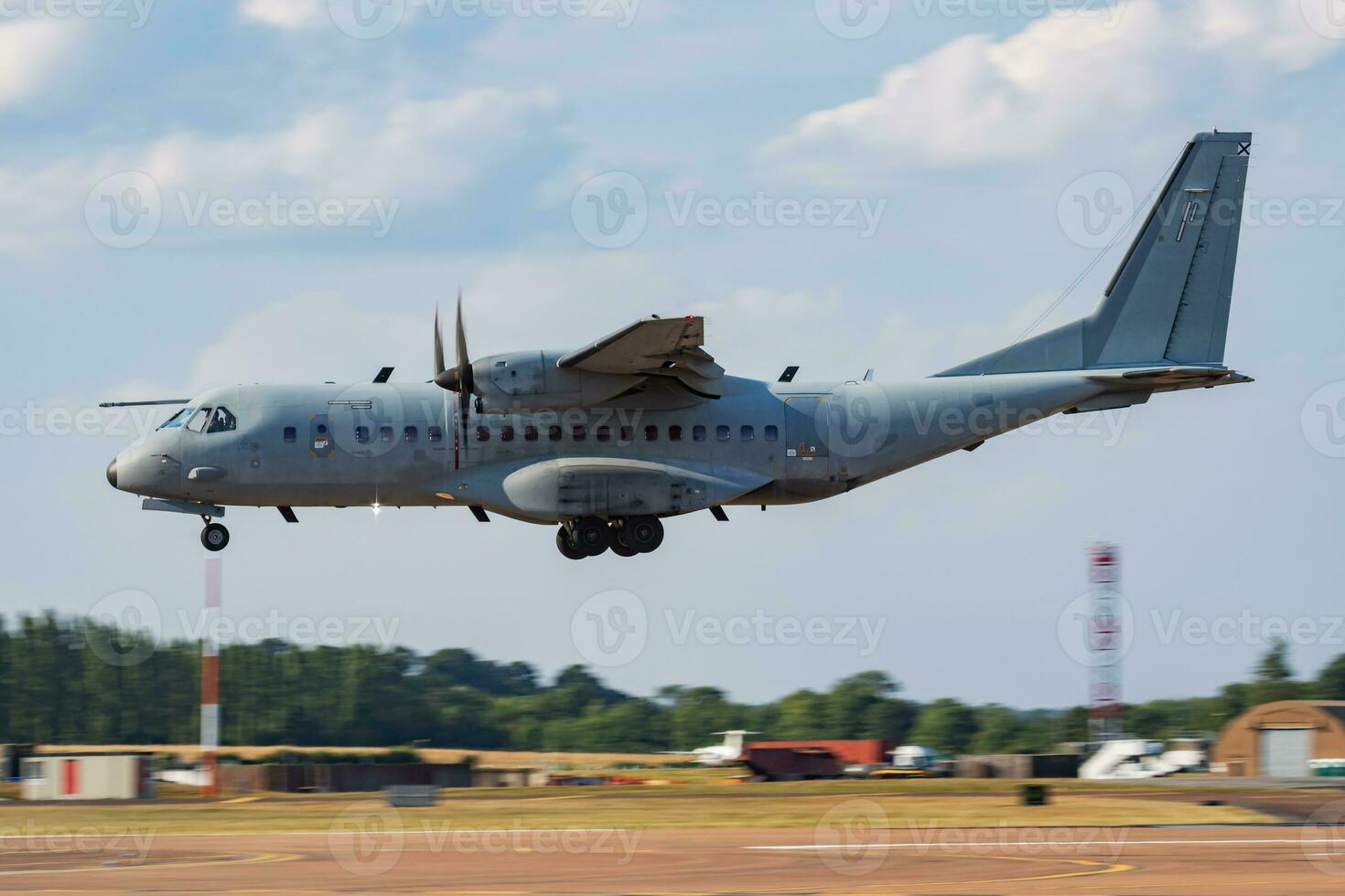 Untitled military transport plane at air base. Airport and airfield. Air force and army flight operation. Aviation and aircraft. Air lift. Military industry. Fly and flying. photo