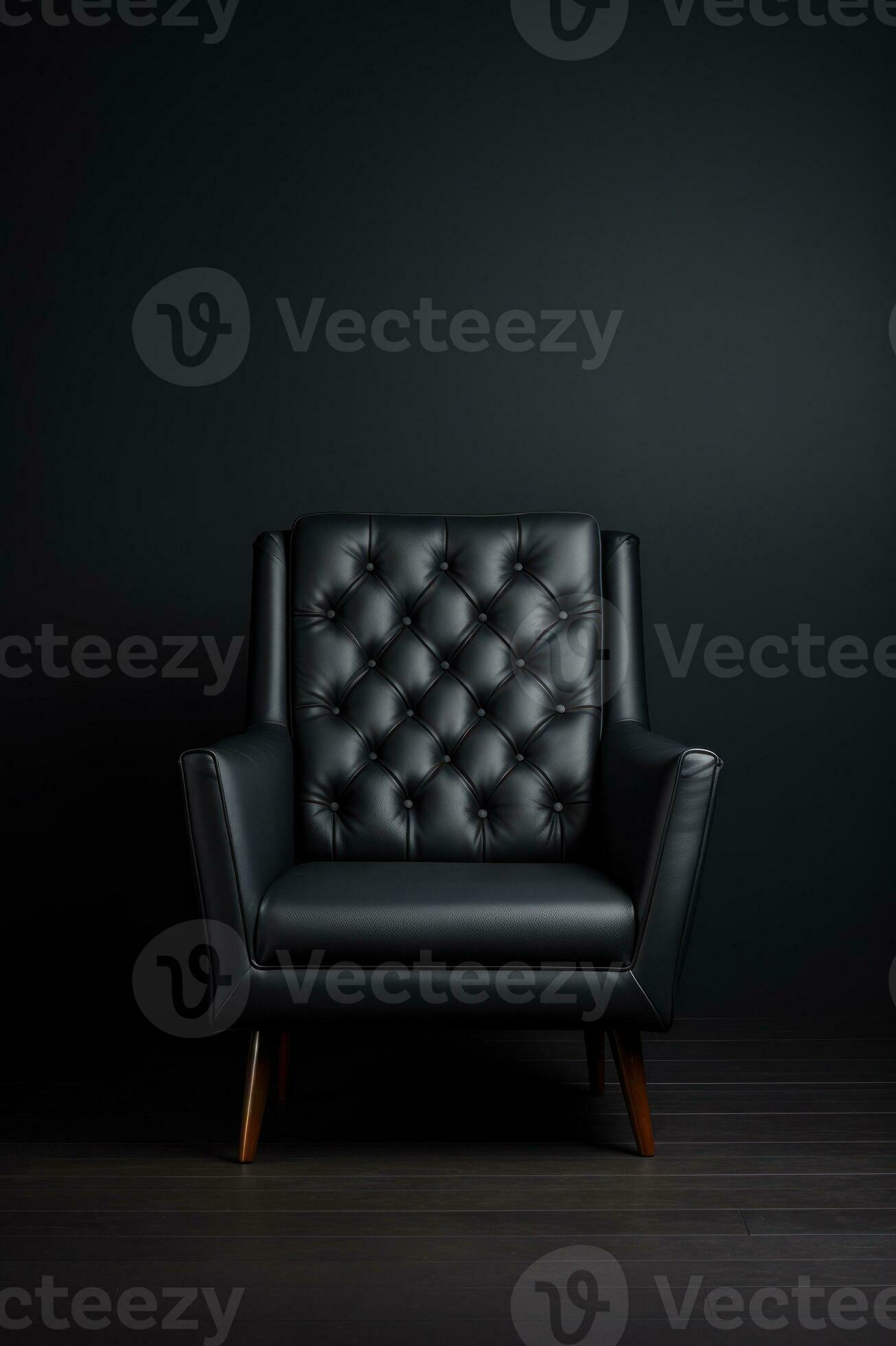 One black leather armchair on solid dark gray background. Comfortable