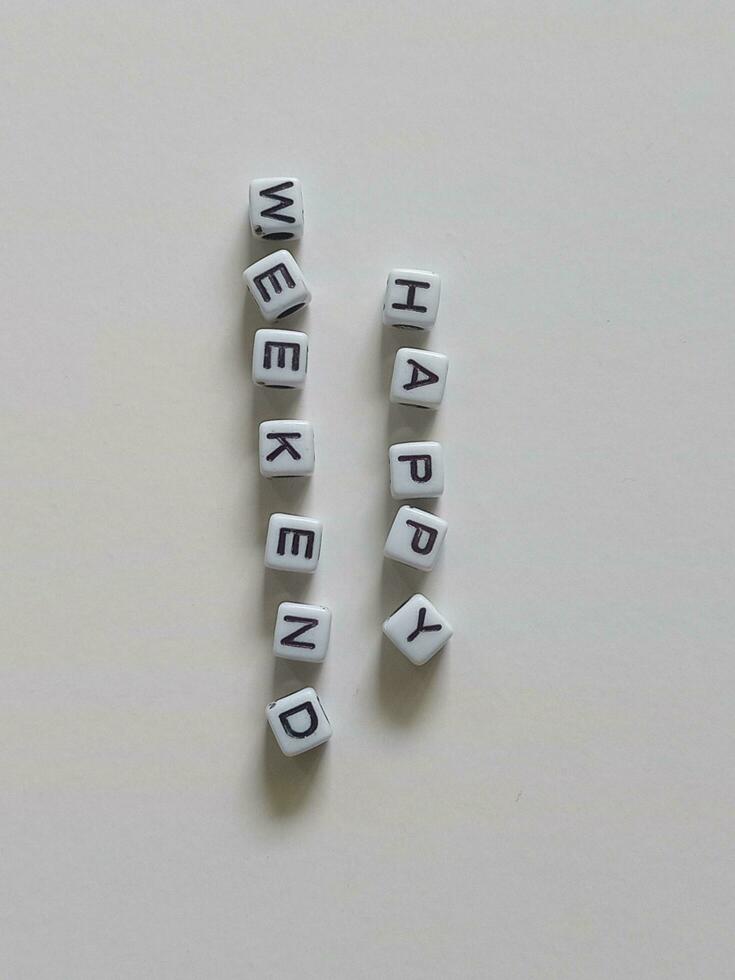 Happy weekend greeting text using alphabet beads photo