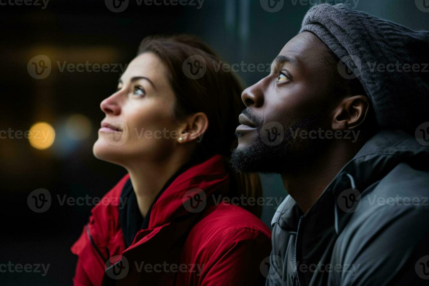 Two individuals in close proximity side by side contemplating photo