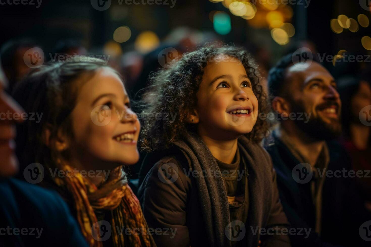 Wide eyed kids in the audience captivated by the magic of live theater unfolding before them photo