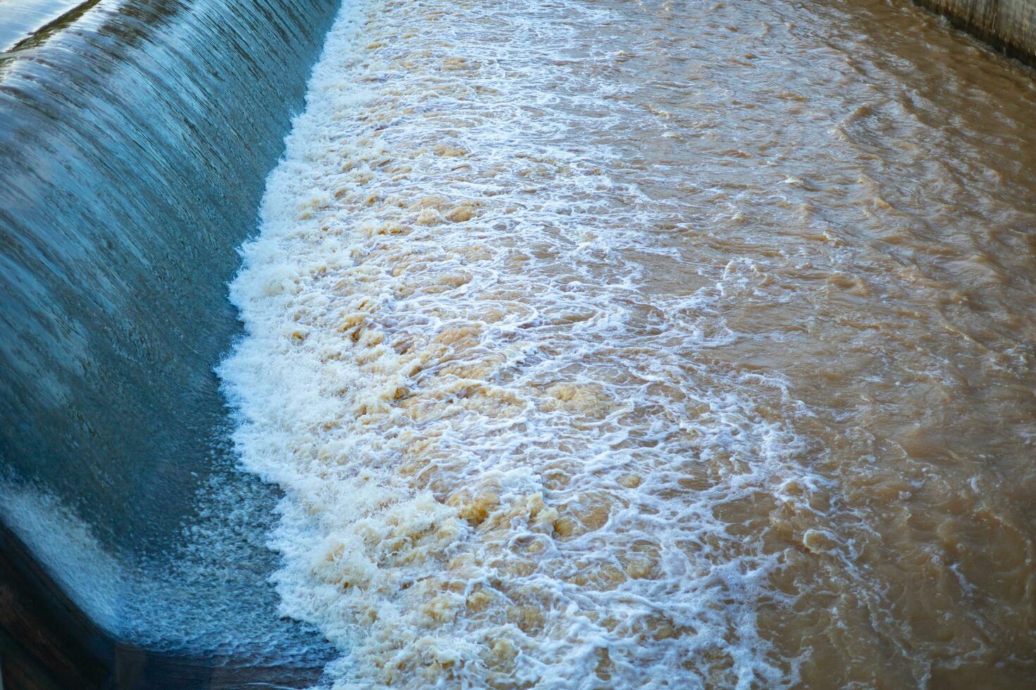 Water overflows from a weir caused by heavy rain in Thailand. photo