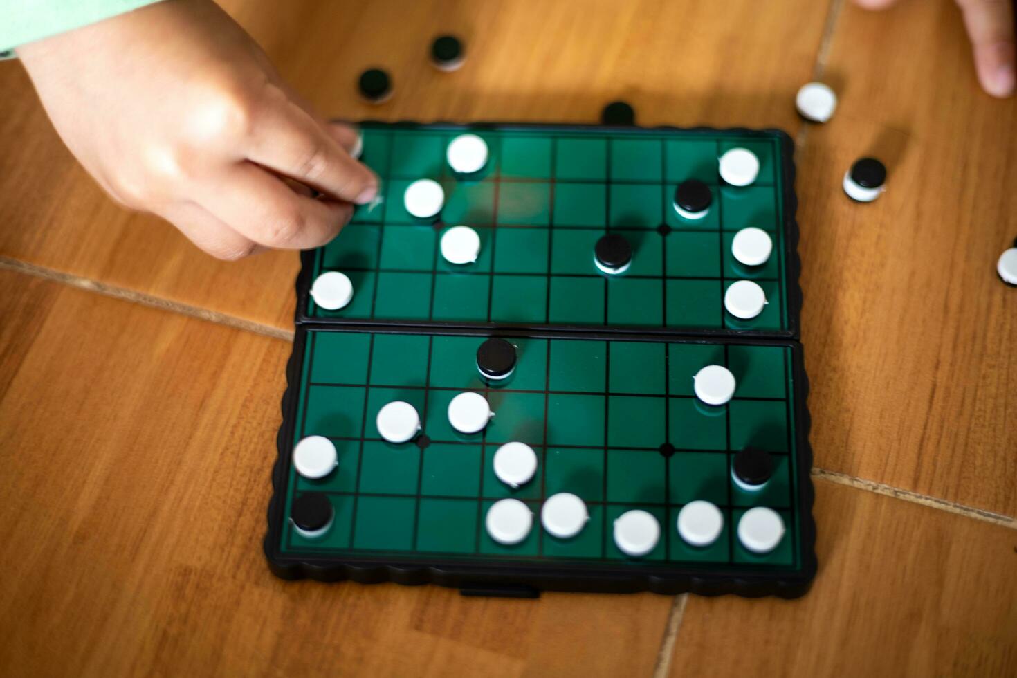 Children's hands learning to play Go on a Go photo