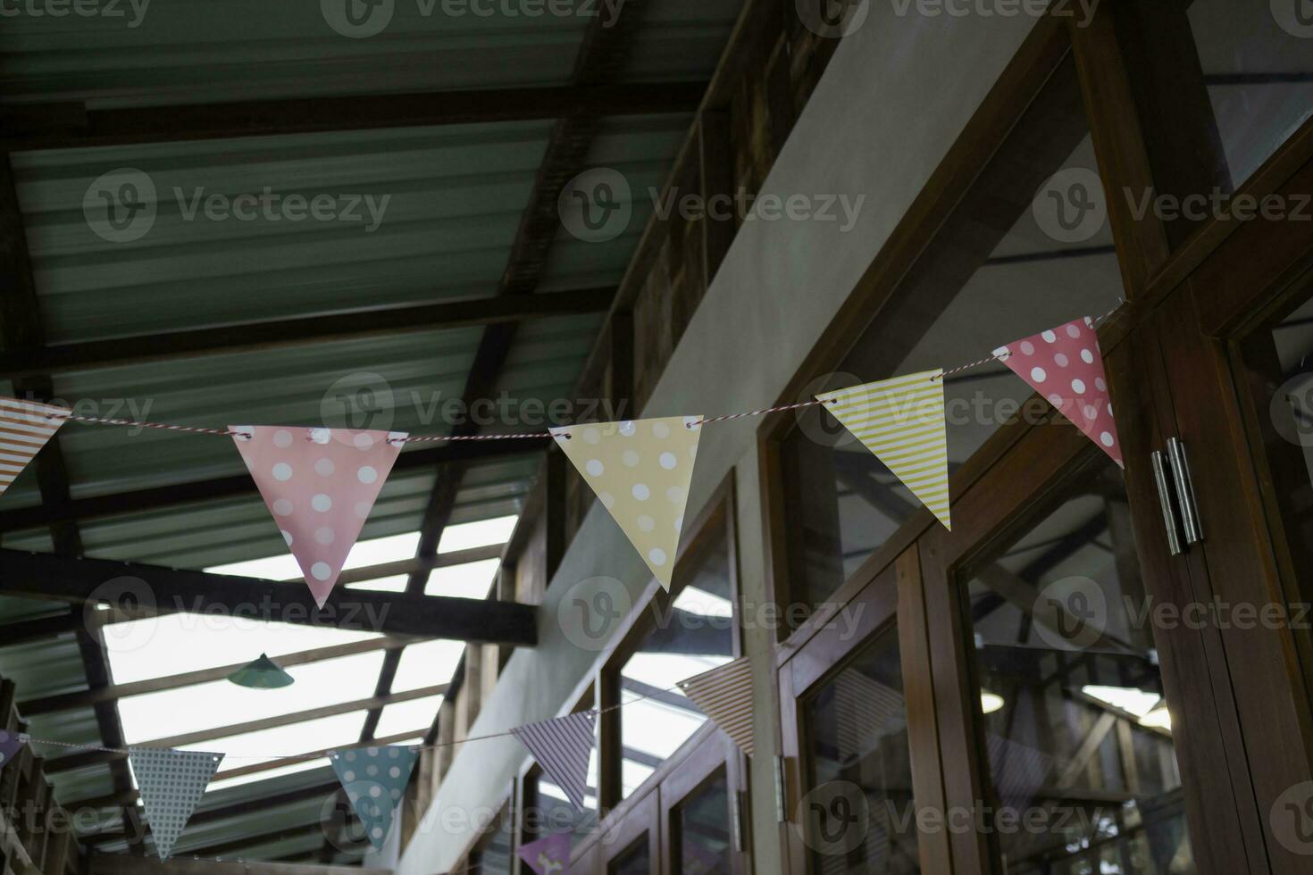 Festive colorful flags decorated on wooden architecture photo